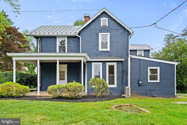 view of front facade with a front lawn and covered porch