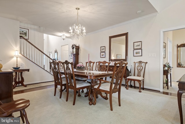 dining space with crown molding, light carpet, and a chandelier