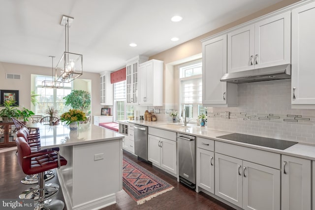 kitchen featuring sink, black electric stovetop, white cabinetry, and dishwasher