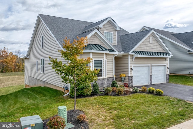 view of front of home with a front lawn and a garage