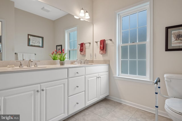 bathroom featuring vanity, toilet, and tile patterned floors