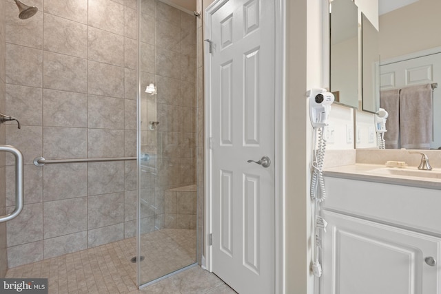 bathroom with vanity, tile patterned floors, and a shower with door