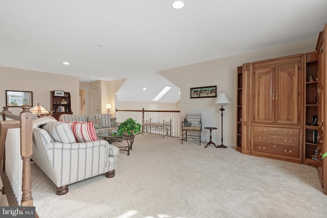 carpeted living room featuring a skylight