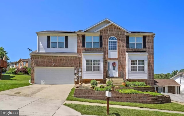 view of front of home featuring a front yard and a garage