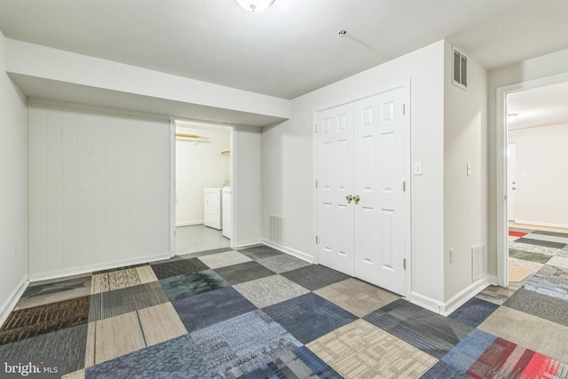 basement with washer and clothes dryer and dark carpet