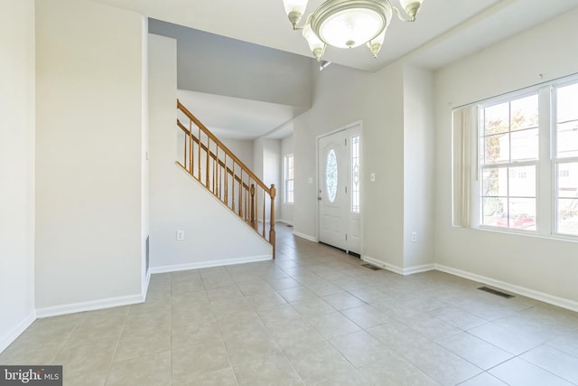 entryway featuring a chandelier and light tile patterned floors