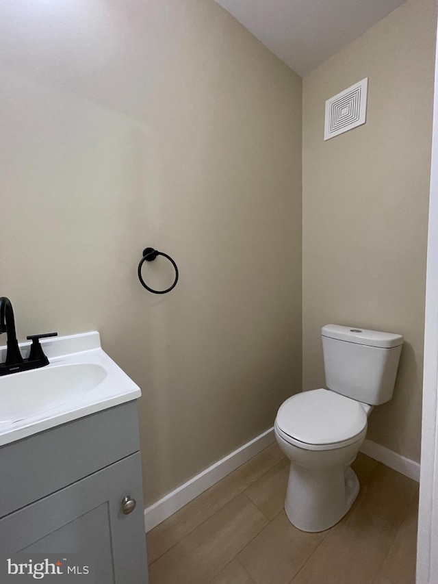 bathroom with vanity, tile patterned flooring, and toilet