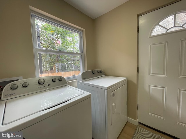 laundry room featuring light tile patterned floors and washing machine and dryer