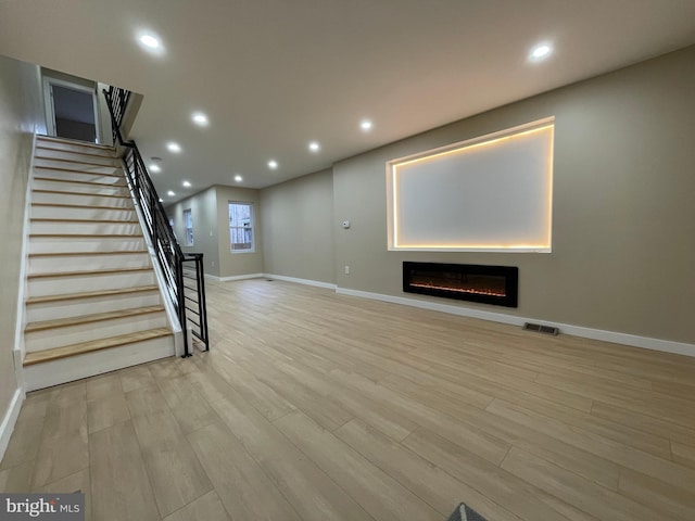 unfurnished living room featuring light hardwood / wood-style flooring