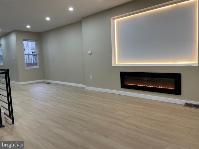 unfurnished living room with light hardwood / wood-style flooring