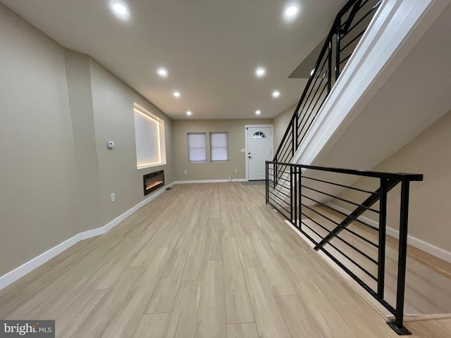 interior space with heating unit and light hardwood / wood-style flooring