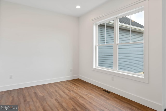 spare room with wood-type flooring