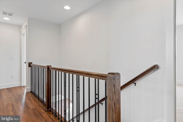 corridor with hardwood / wood-style floors