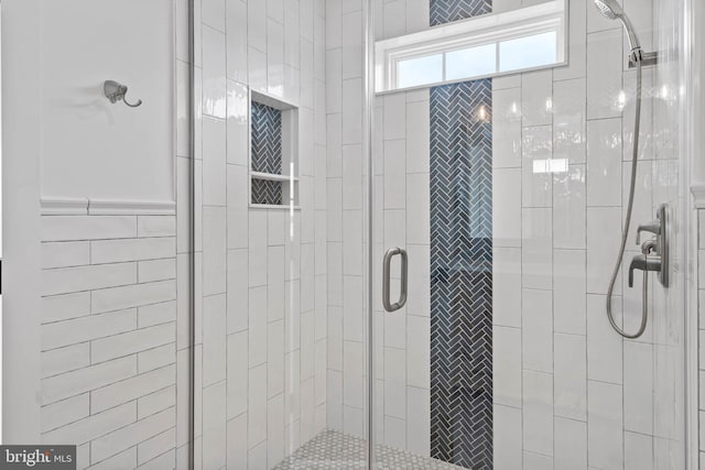 bathroom with a shower with door