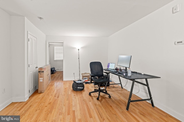 office area featuring baseboard heating and light hardwood / wood-style flooring