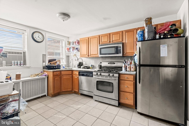 kitchen with light tile patterned flooring, cooling unit, decorative backsplash, appliances with stainless steel finishes, and radiator heating unit