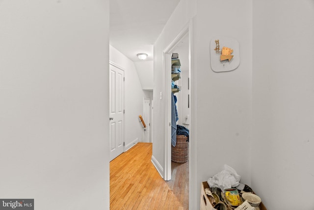 corridor with hardwood / wood-style floors