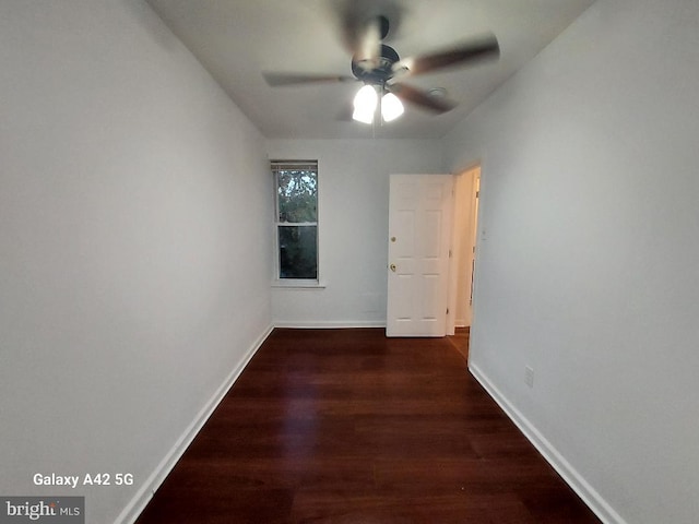 spare room with ceiling fan and dark wood-type flooring