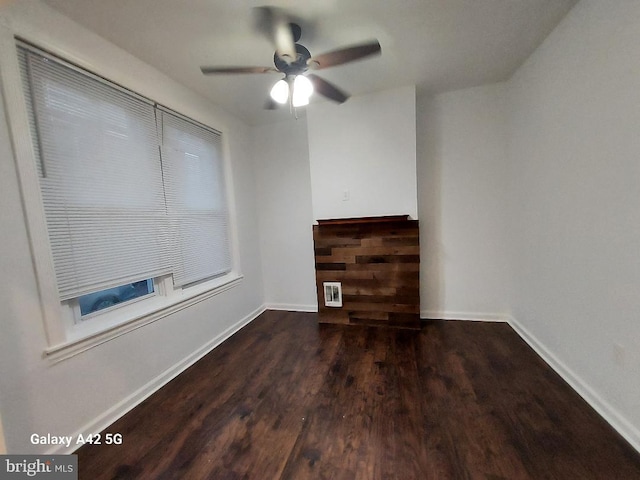 unfurnished room with ceiling fan and dark hardwood / wood-style floors