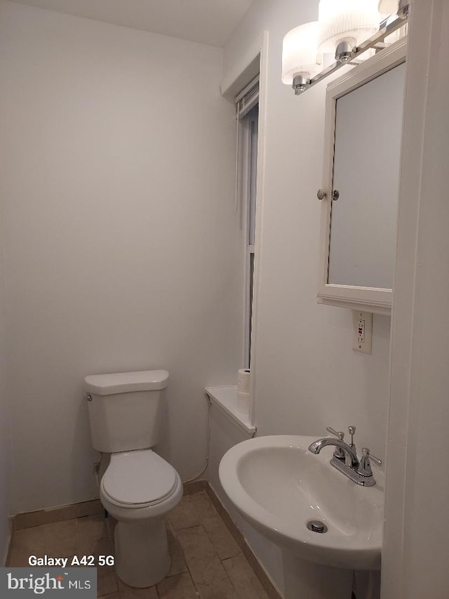 bathroom with tile patterned floors, toilet, and sink