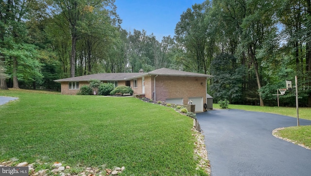 view of front of property with a front yard and a garage