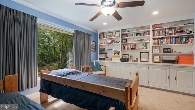 carpeted bedroom with ornamental molding and ceiling fan