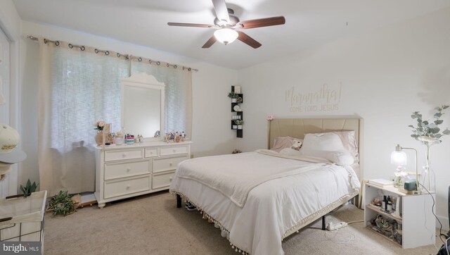 bedroom featuring ceiling fan and light colored carpet