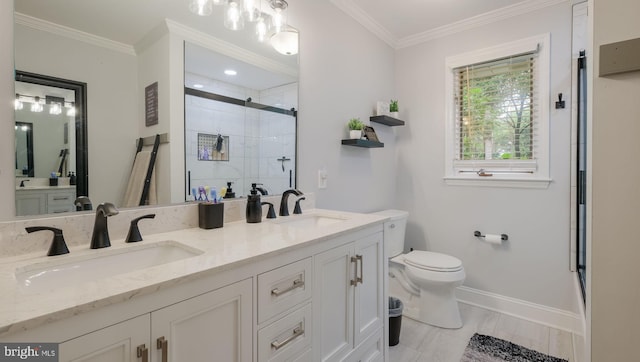 bathroom with ornamental molding, vanity, toilet, and an enclosed shower