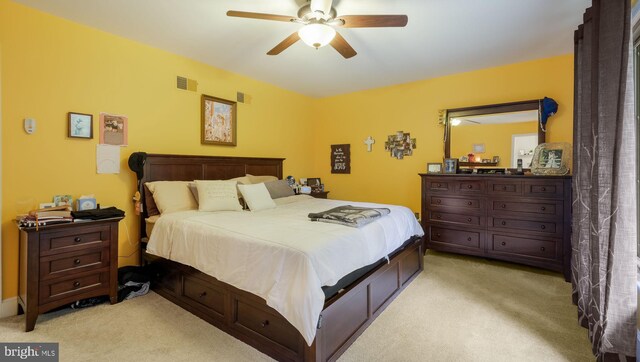 carpeted bedroom featuring ceiling fan