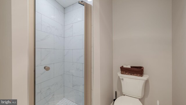 bathroom featuring an enclosed shower and toilet