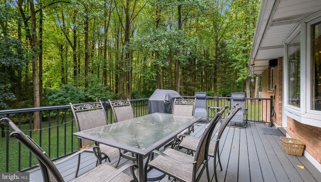 wooden deck featuring a grill