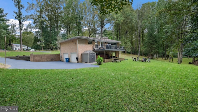 view of yard with a wooden deck and a patio area