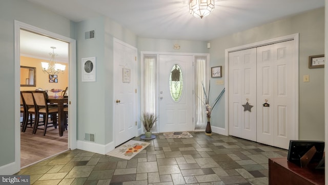 entrance foyer with a notable chandelier and dark wood-type flooring