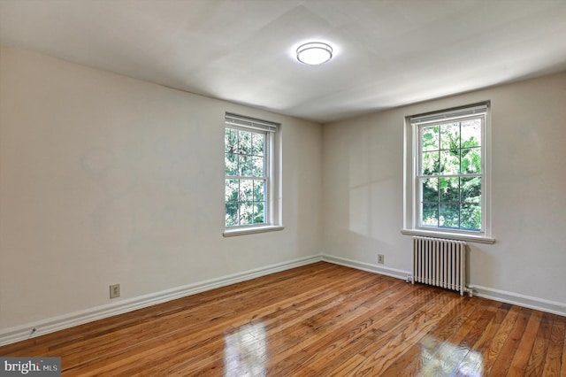 spare room with light hardwood / wood-style flooring and radiator