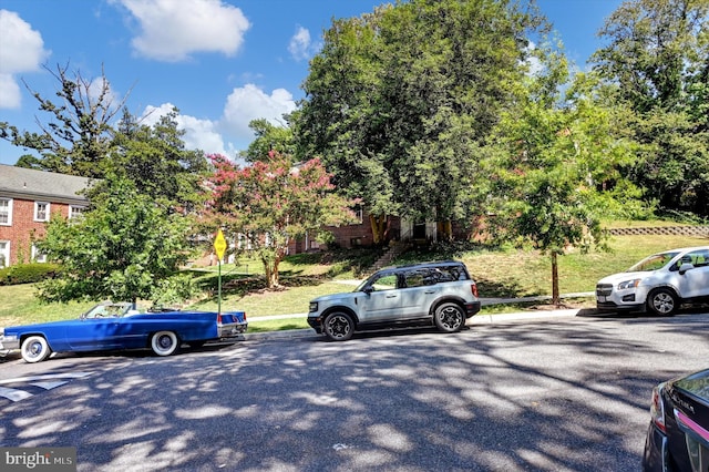 view of parking featuring a lawn