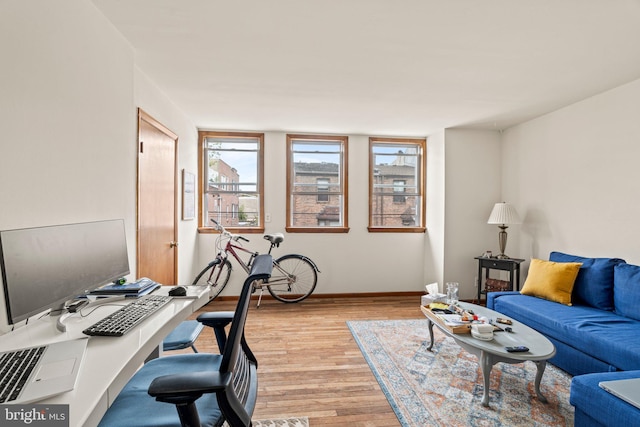 office area with light hardwood / wood-style floors