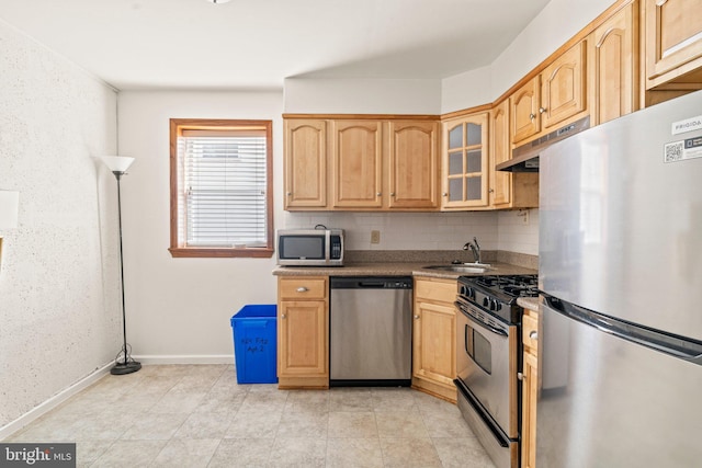 kitchen with light tile patterned floors, sink, tasteful backsplash, stainless steel appliances, and light brown cabinetry