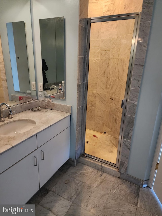 bathroom with walk in shower and vanity