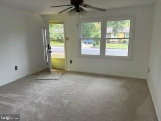 carpeted empty room featuring ceiling fan