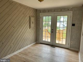 doorway to outside with light hardwood / wood-style floors and french doors