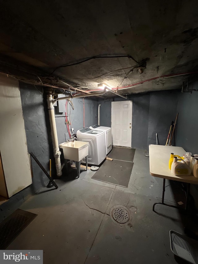 basement featuring separate washer and dryer and sink