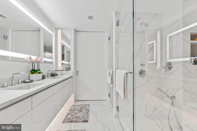 bathroom with a shower with shower door and vanity