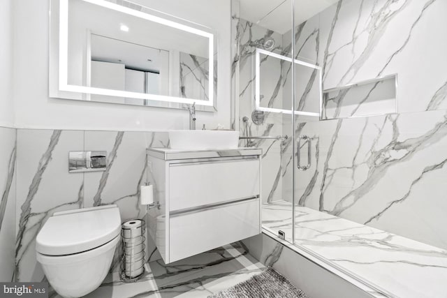 925 H St NW Unit 901/902, Washington, DC 20001 - full bathroom with marble finish floors, a marble finish shower, vanity, toilet, and tile walls