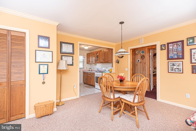 dining room featuring crown molding and light carpet