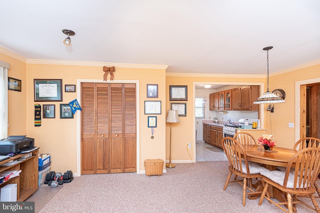 dining room featuring crown molding and light colored carpet