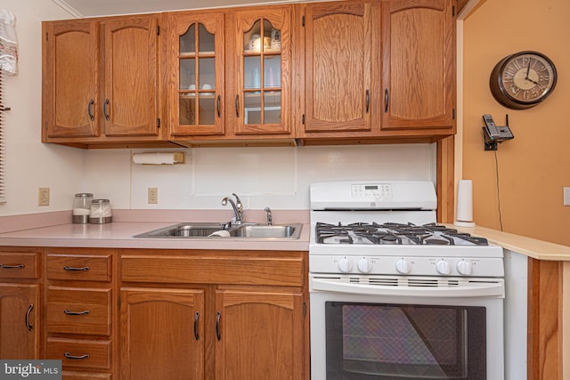 kitchen featuring white gas range and sink