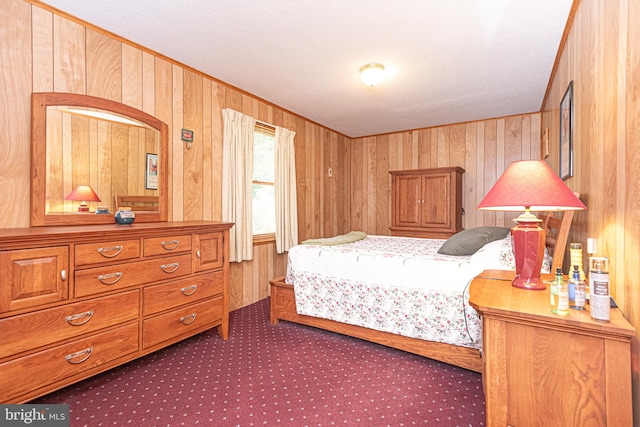 bedroom with a textured ceiling and wooden walls