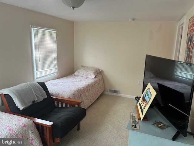 bedroom with light colored carpet