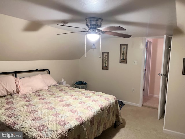 bedroom with lofted ceiling, ceiling fan, and light colored carpet