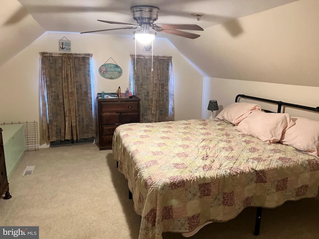 bedroom with ceiling fan, light colored carpet, and vaulted ceiling